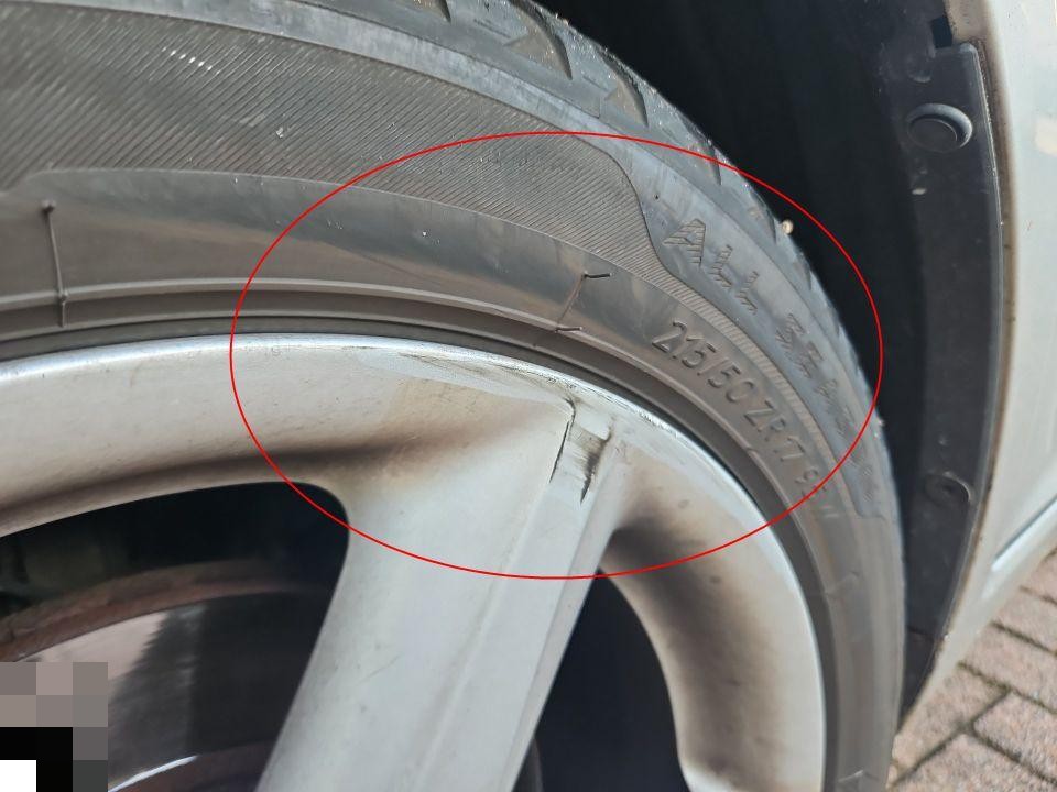 Detailaufnahme Reifenflanke mit Beschädigung, rot markiert, Reifengröße 215/50ZR17 sichtbar